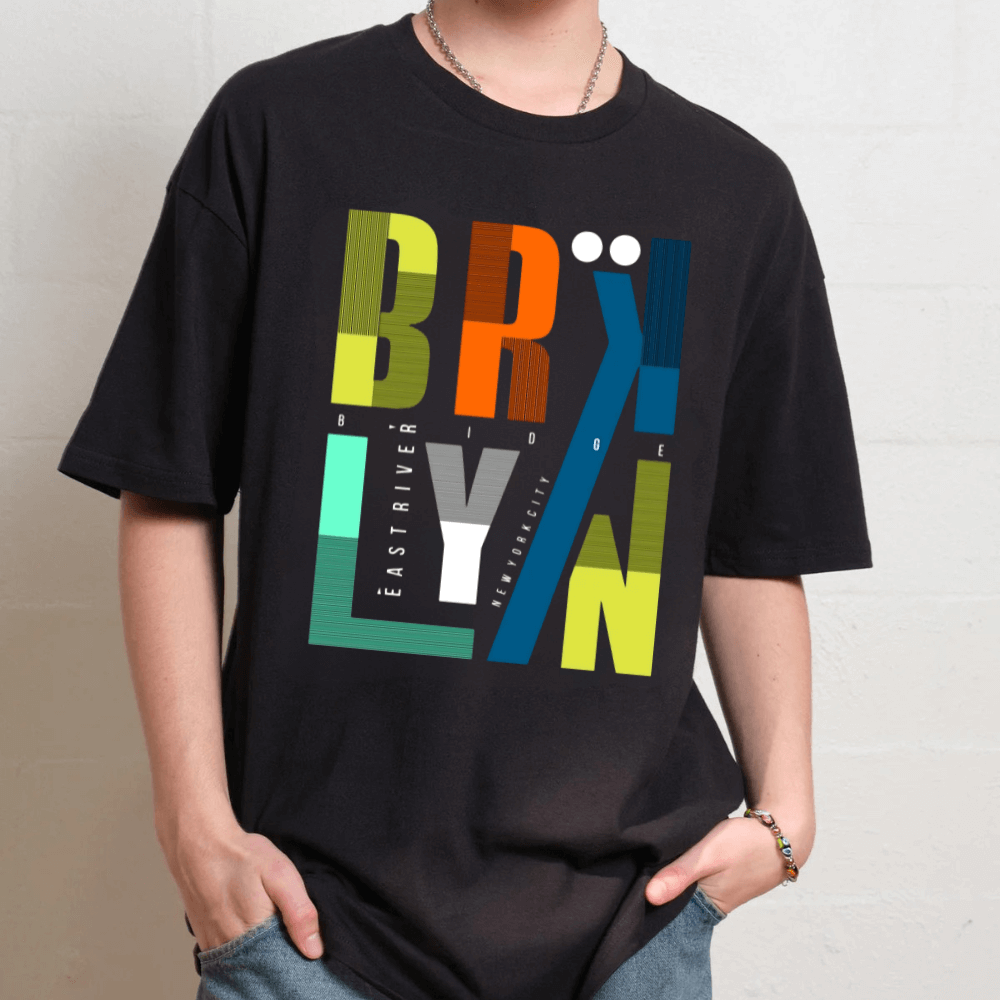 Person wearing a black t-shirt with colorful 'BROOKLYN' graphic design.