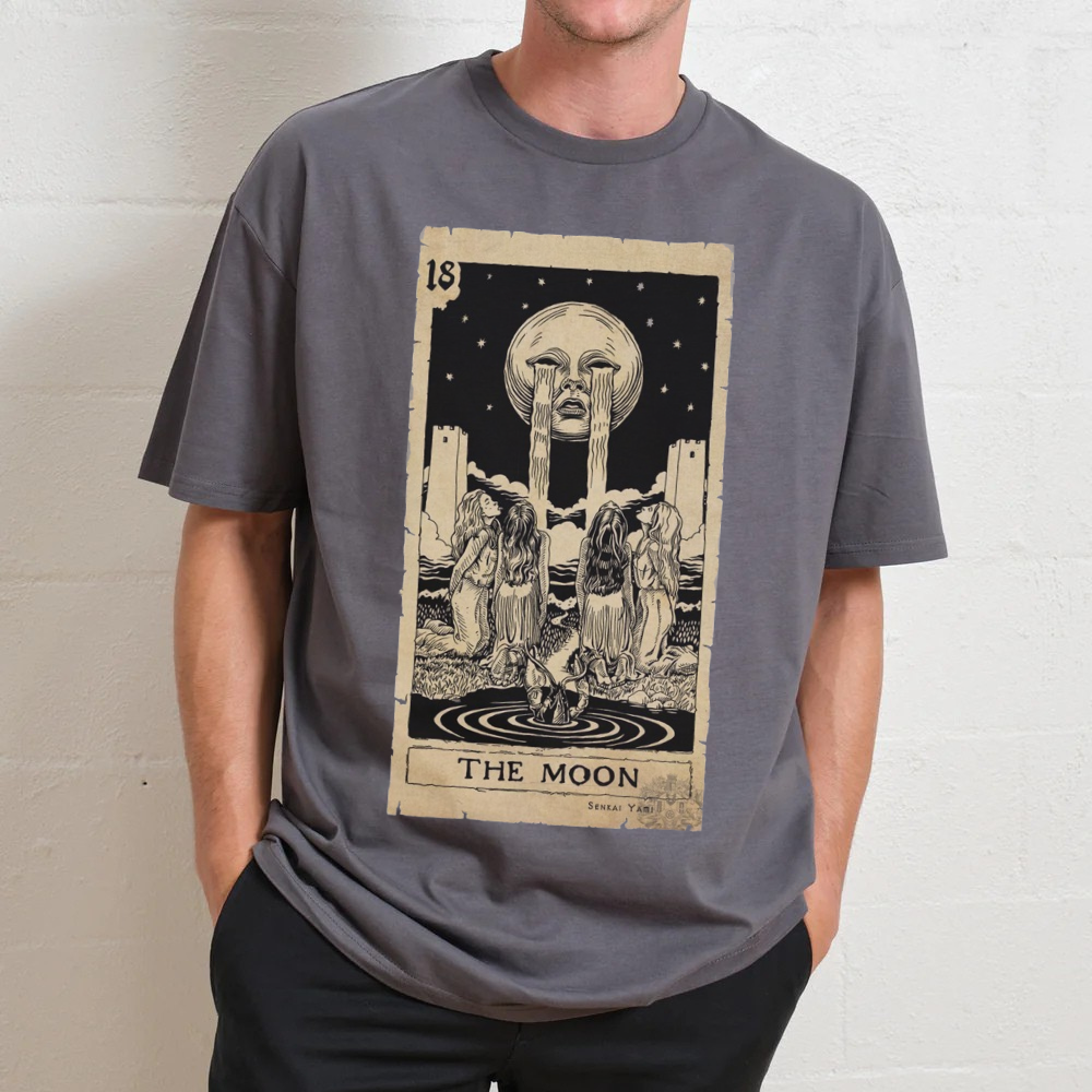 Man wearing oversized gray tarot-themed T-shirt featuring 'The Moon' graphic, inspired by 90s style.