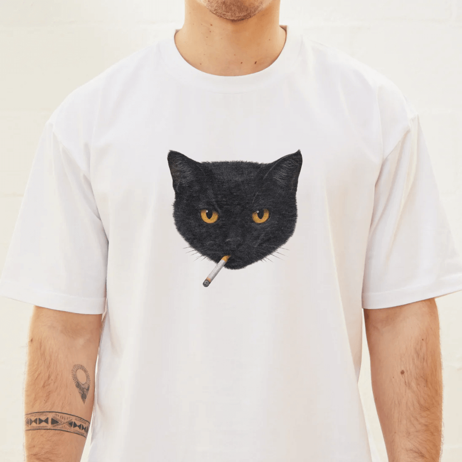 White t-shirt with a black cat graphic holding a cigarette, worn by a person.