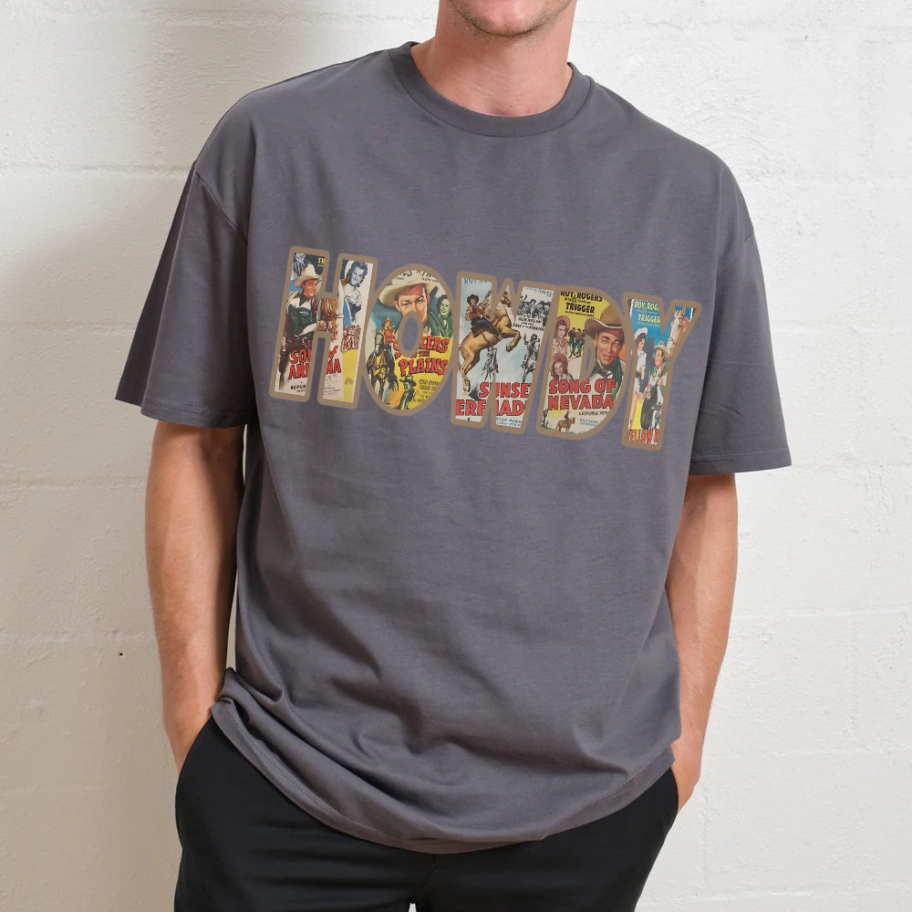 Person wearing a gray t-shirt with vintage-style graphic design on a plain background