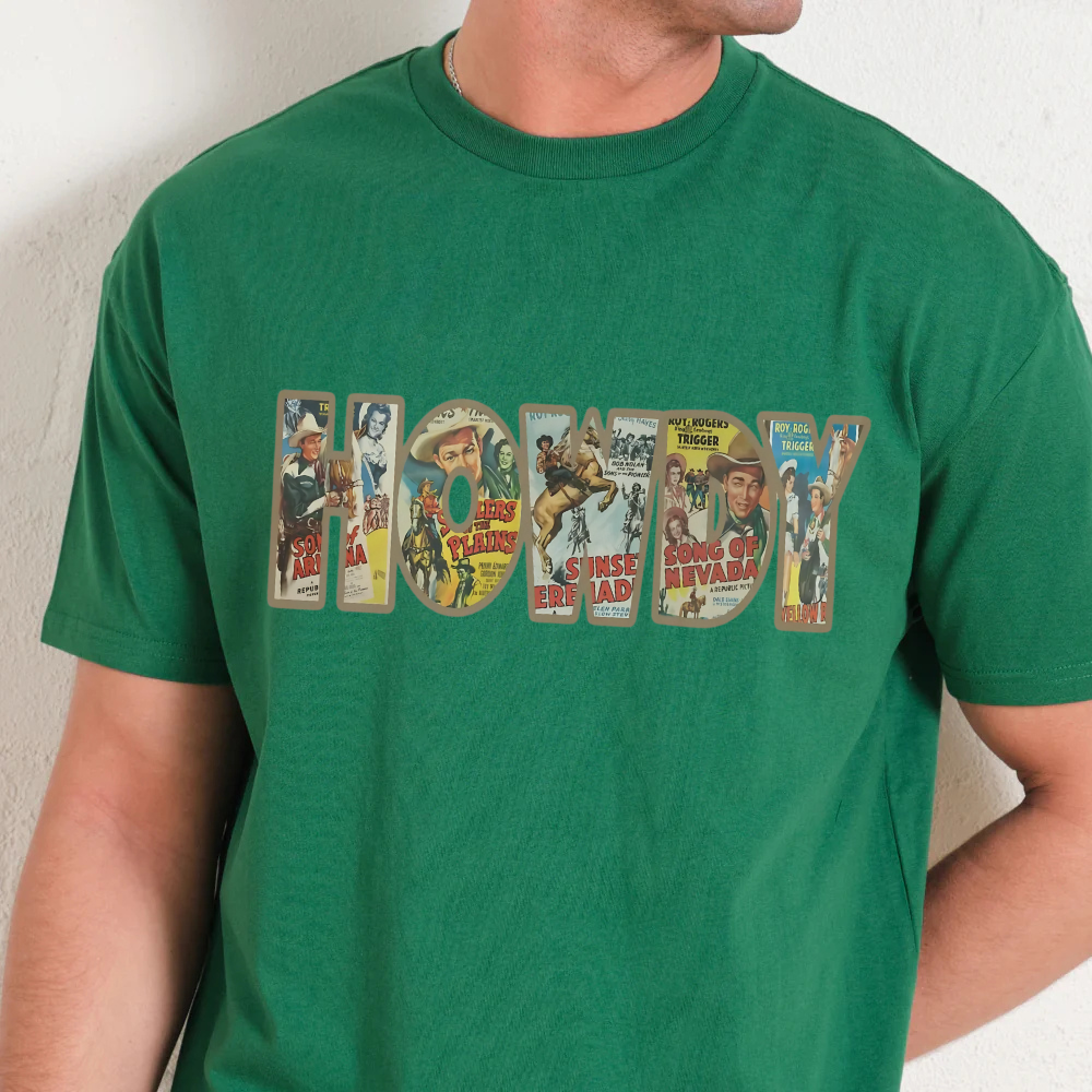 Green t-shirt with vintage-style text design featuring images of cowboys and western scenes.