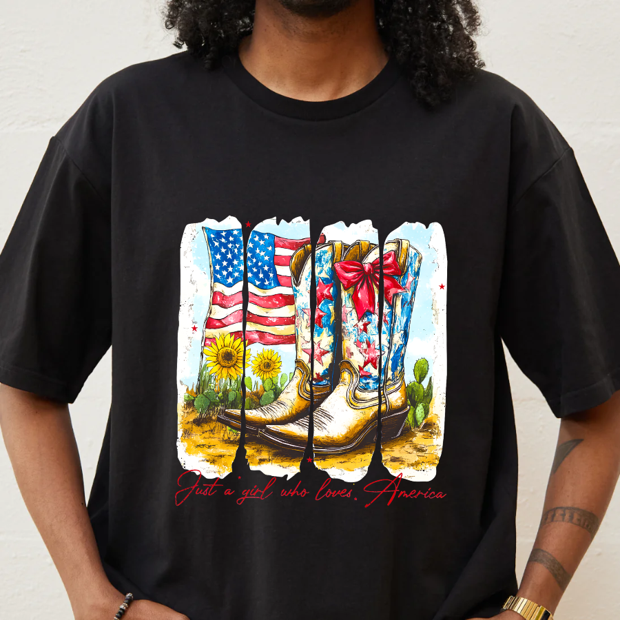 Black t-shirt with a colorful graphic of boots, American flag, and flowers on a plain background