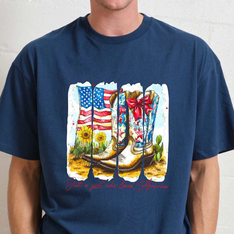 Navy blue t-shirt with a graphic of cowboy boots, American flag, and flowers on a plain background