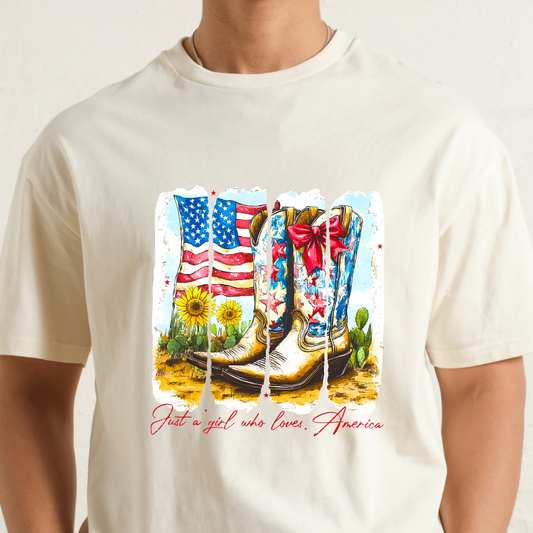 Natural t-shirt with a graphic of boots, American flag, and cactus on a white background