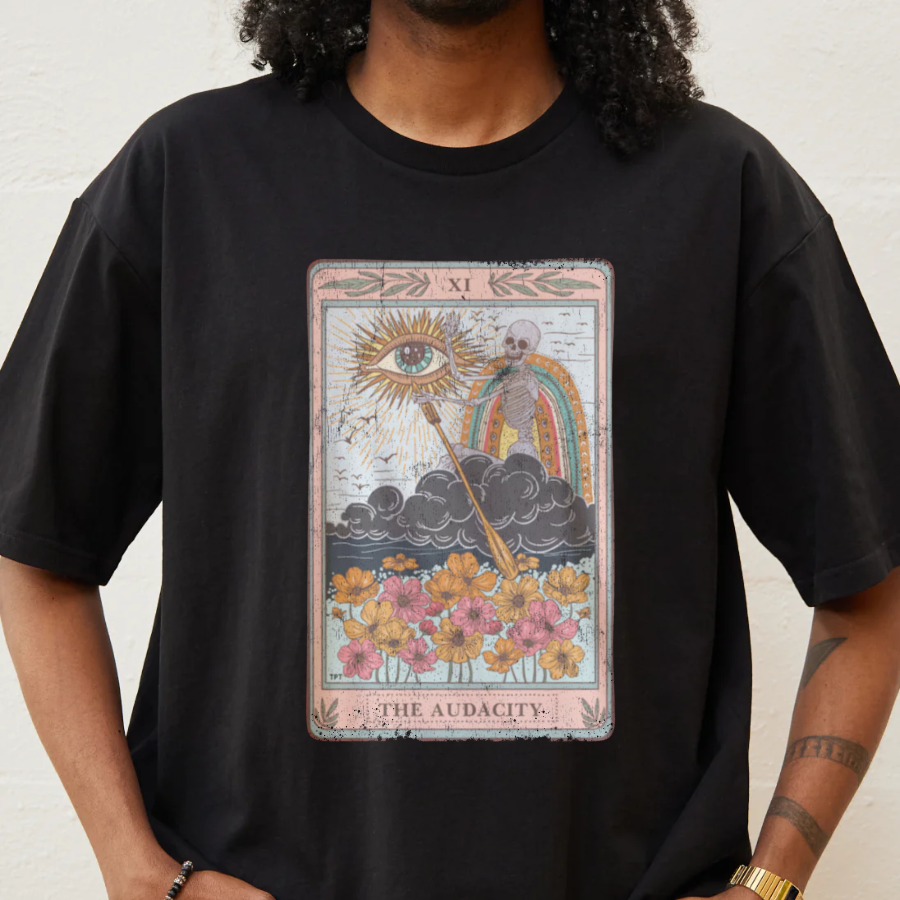 Person wearing a black t-shirt with a tarot card design labeled 'The Audacity'.
