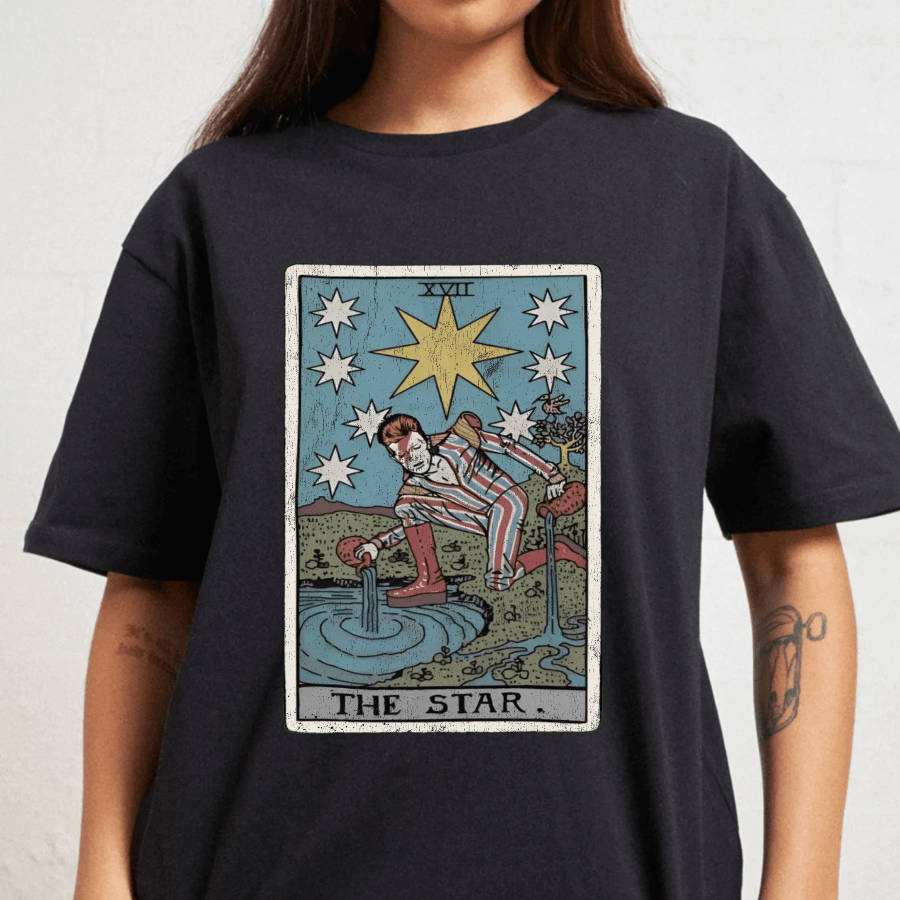 Person wearing a black t-shirt with 'The Star' tarot card design.