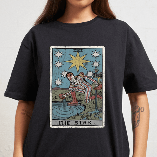 Person wearing a black t-shirt with 'The Star' tarot card design.