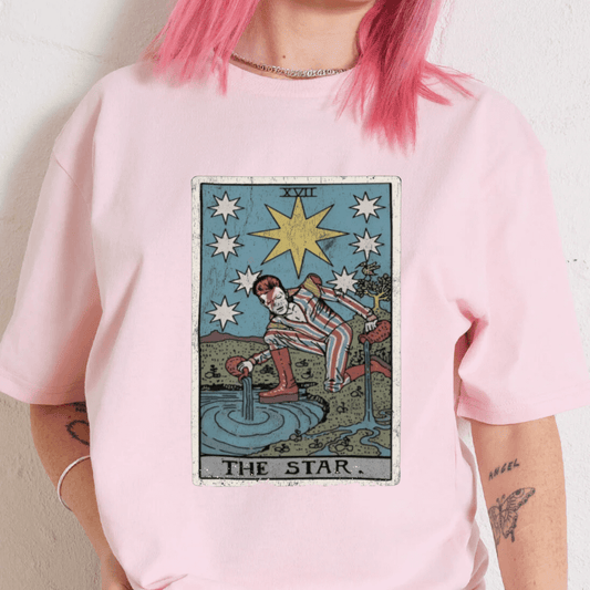 Person wearing a pink t-shirt with 'The Star' tarot card design.