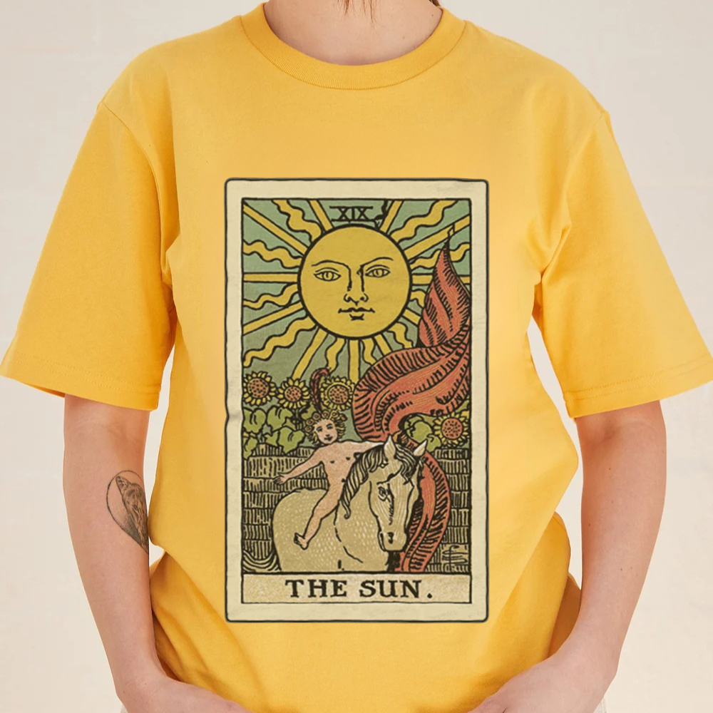 Yellow t-shirt with 'The Sun' tarot card design worn by a person.