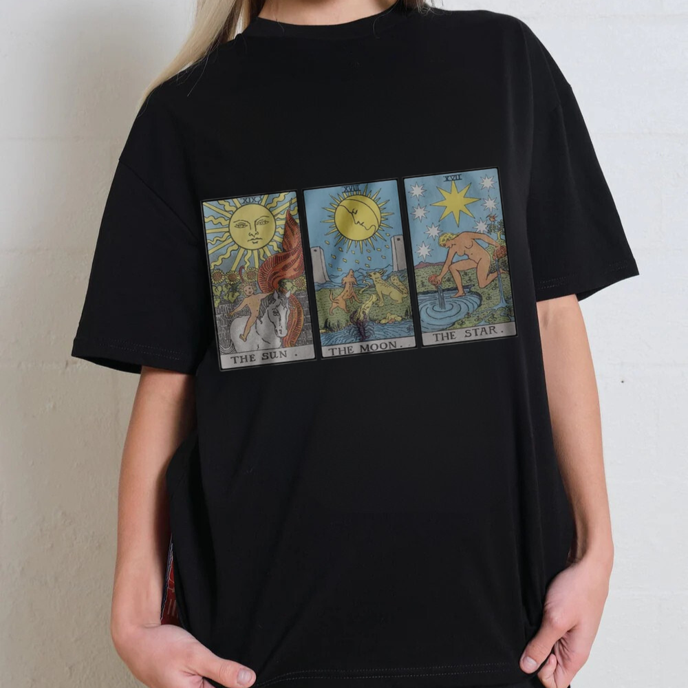 Black t-shirt with tarot card designs worn by a person against a neutral background