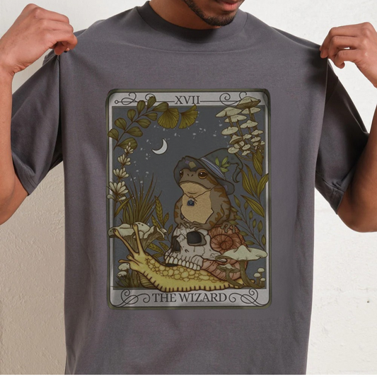 Person wearing a gray t-shirt with colorful text design on a plain background