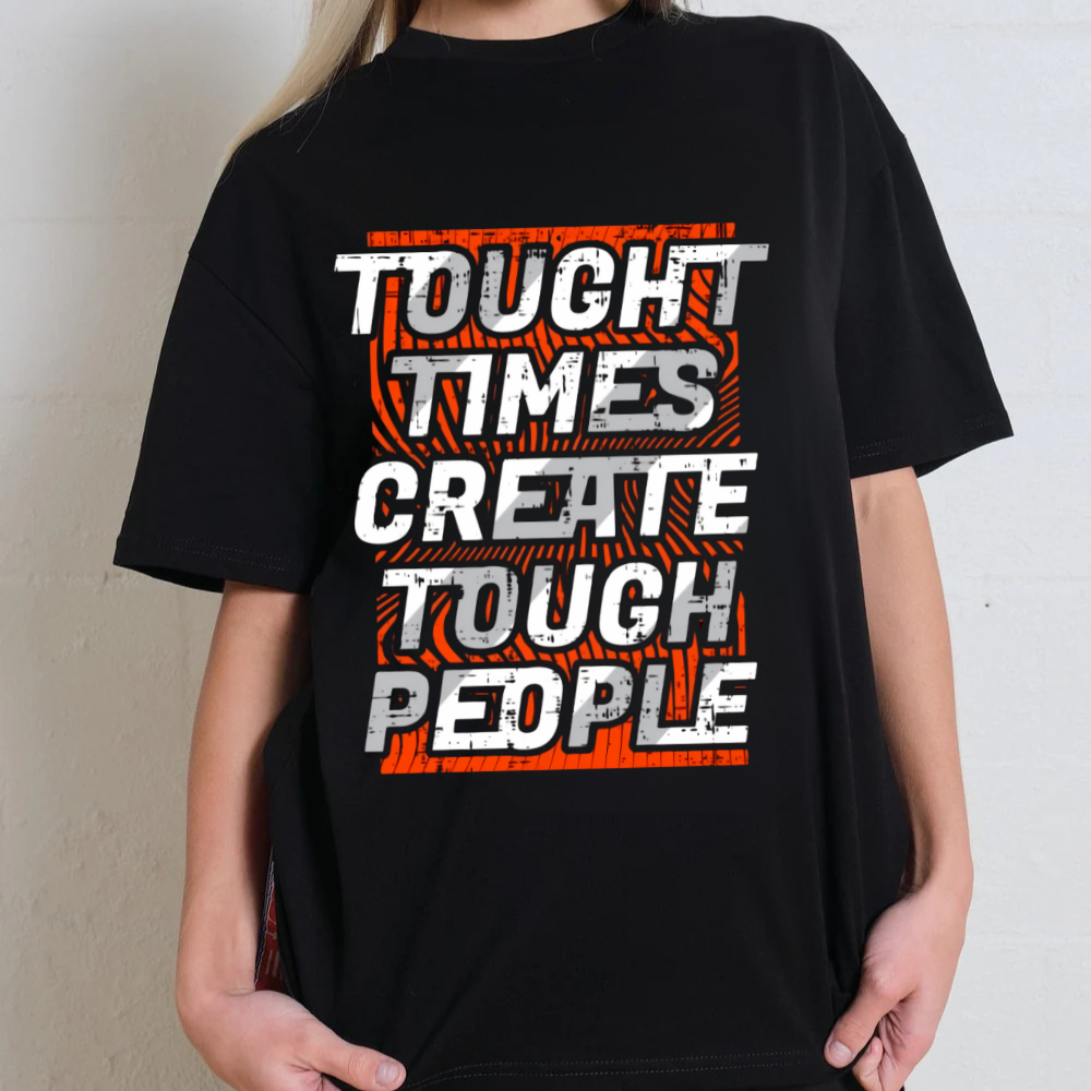 Unisex oversized black T-shirt with 'Tough times create tough people' slogan in bold graphic design.