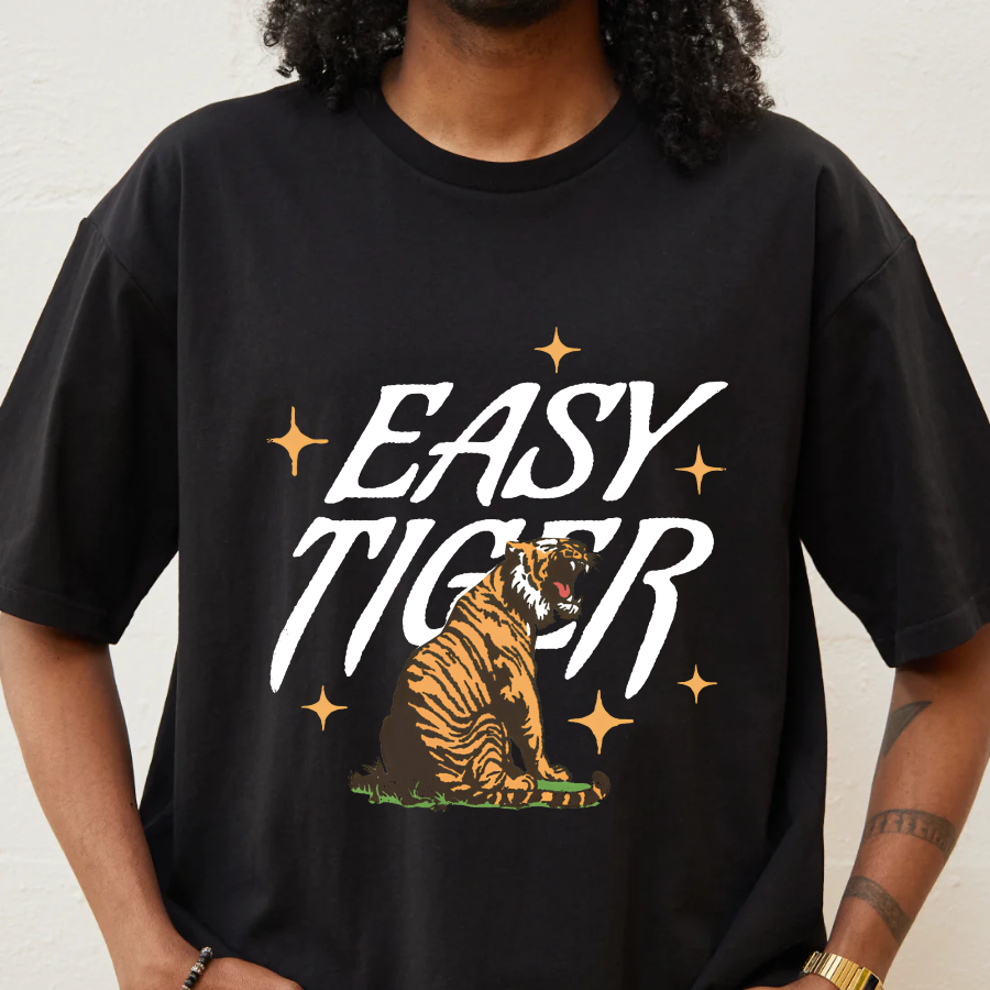 Person wearing a black t-shirt with 'Easy Tiger' graphic design.