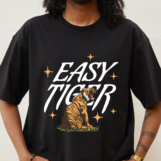 Person wearing a black t-shirt with 'Easy Tiger' graphic design.