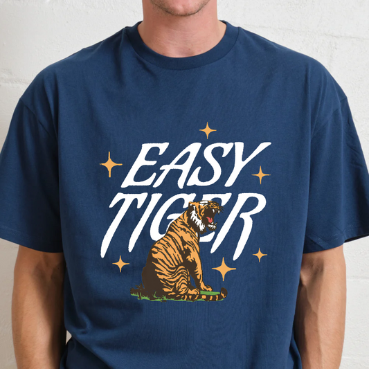 Person wearing a navy blue t-shirt with 'Easy Tiger' graphic design.