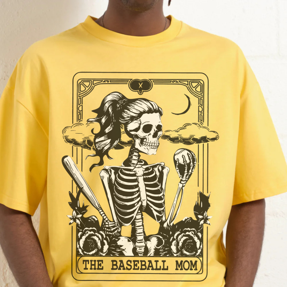 Yellow t-shirt with a skeleton graphic and 'The Baseball Mom' text on a plain background