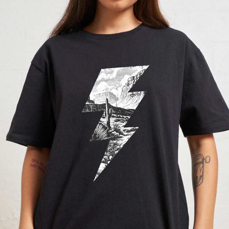 Person wearing a black t-shirt with a white graphic design on a plain background