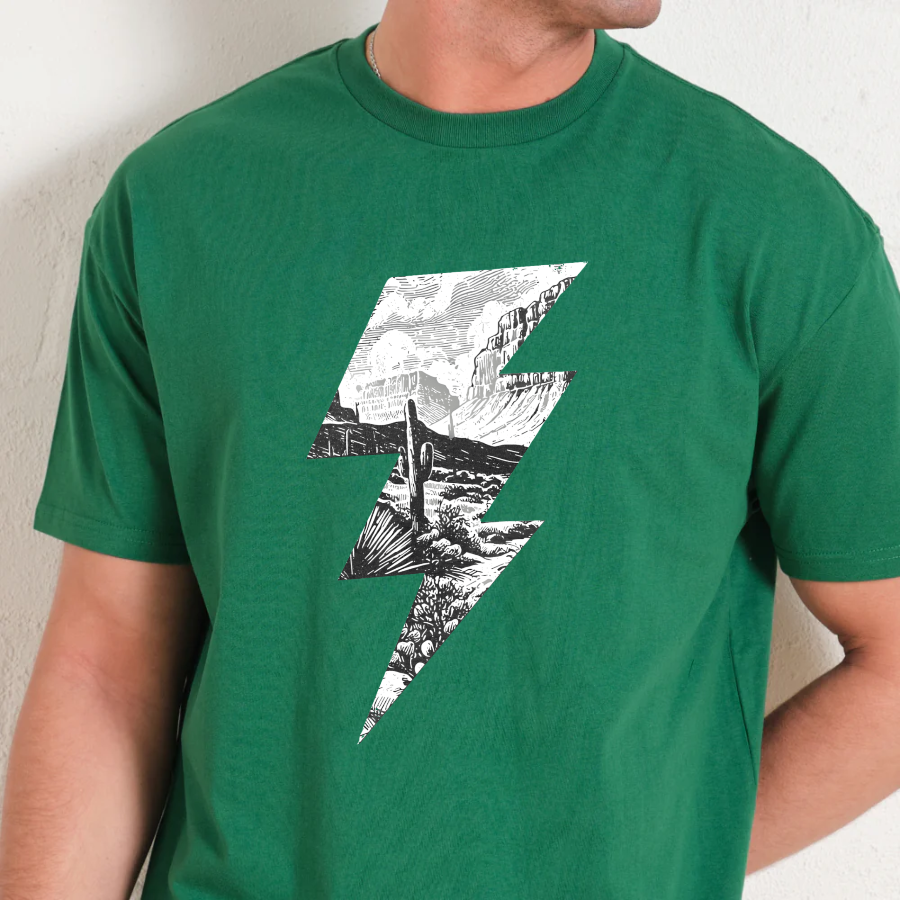 Green t-shirt with a black and white graphic design on a neutral background