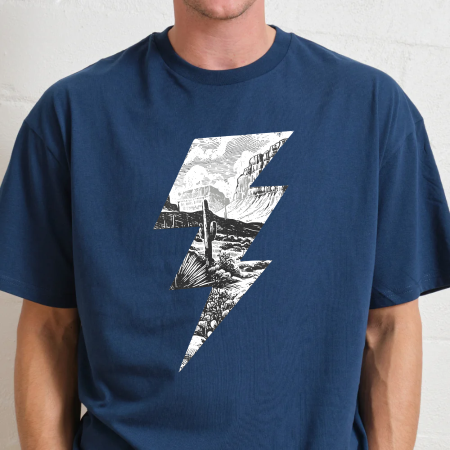 Person wearing a navy t-shirt with a black and white graphic design on a plain background