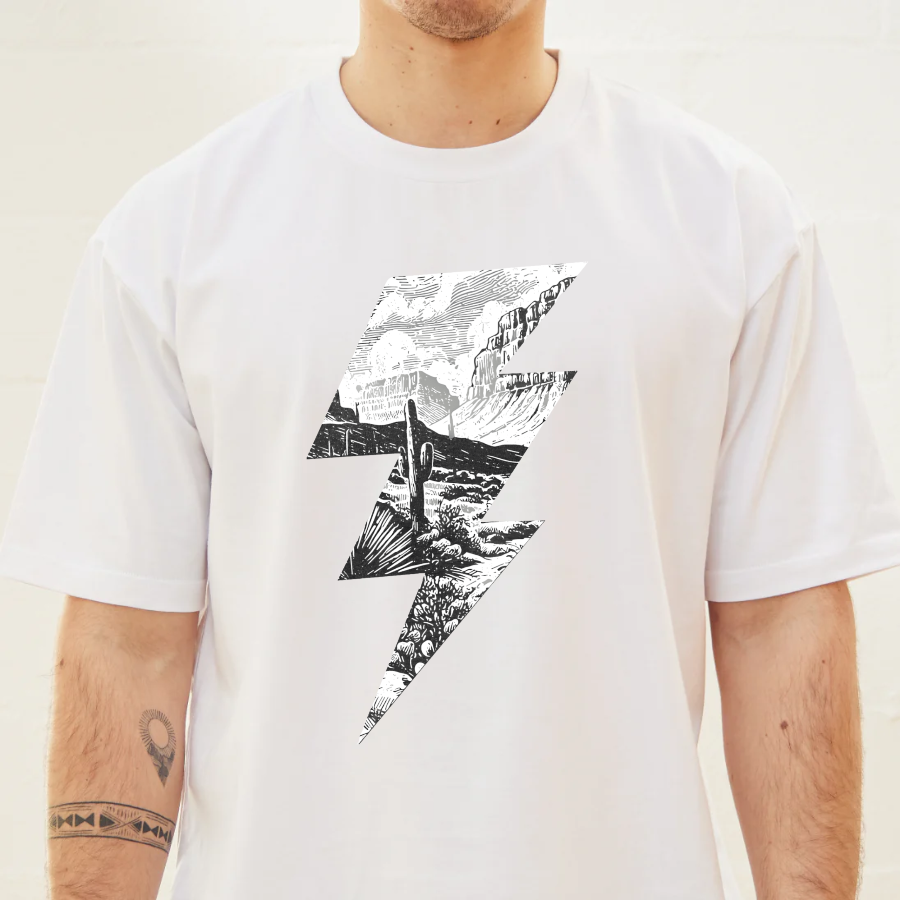 White t-shirt with black and white mountain graphic design worn by a person.