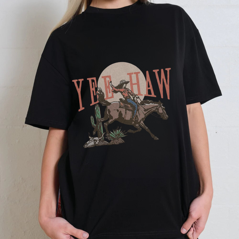 Black t-shirt with a graphic design of a cowboy and 'Yee Haw' text on a plain background