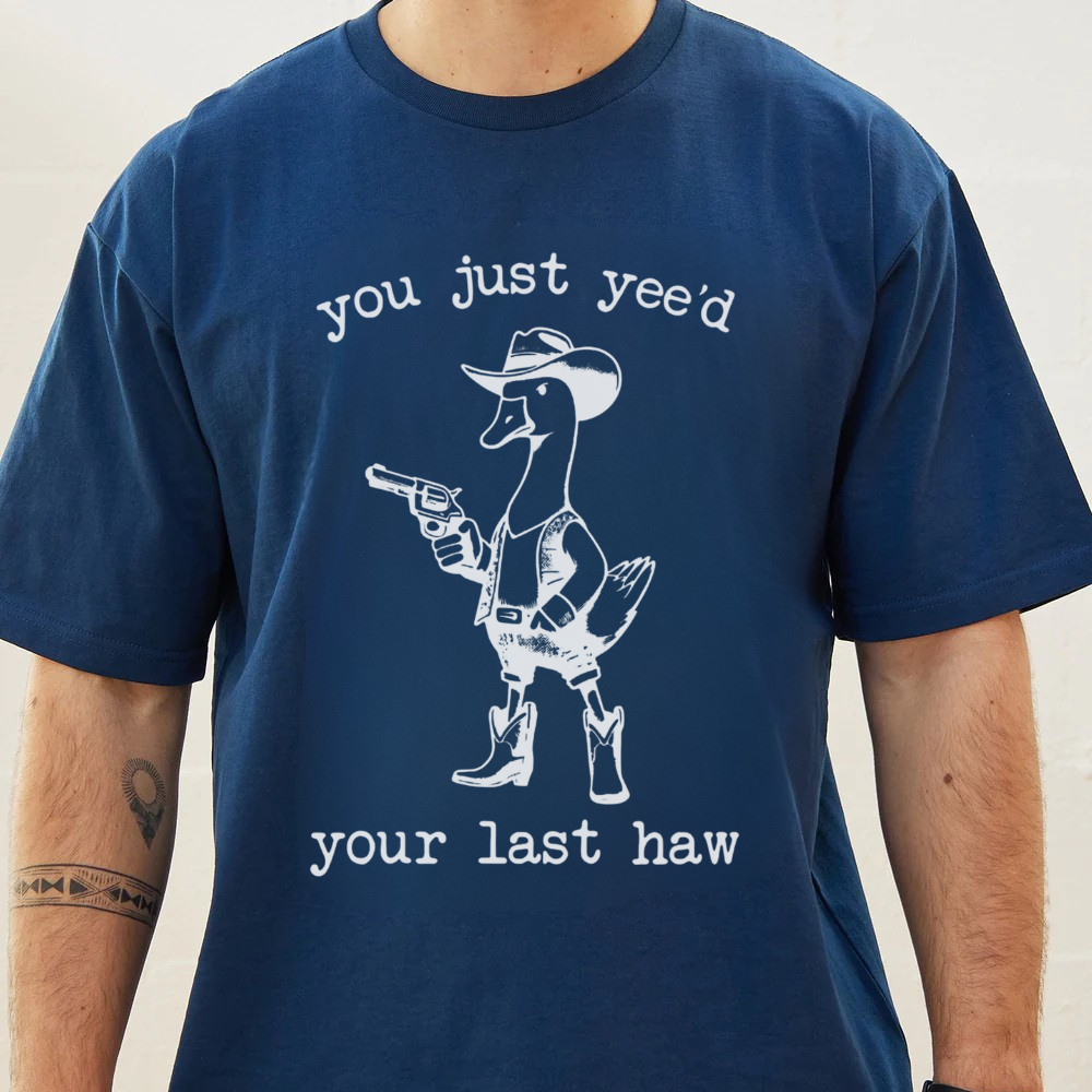 Navy blue t-shirt with a white duck wearing a cowboy hat and boots graphic and text.