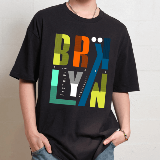 Person wearing a black t-shirt with colorful 'BROOKLYN' graphic design.