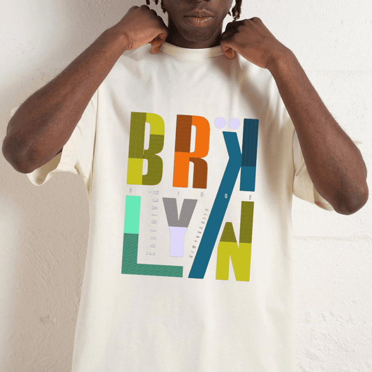 Person wearing a white t-shirt with colorful 'BRYLIVAN' design.