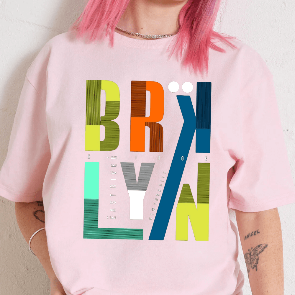 Person wearing a pink sweatshirt with 'Brooklyn' graphic design.
