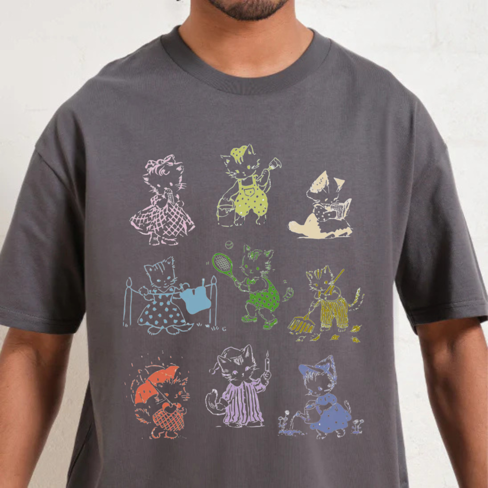 Premium oversized 90s cat graphic t-shirt featuring colorful illustrated cats in playful outfits.