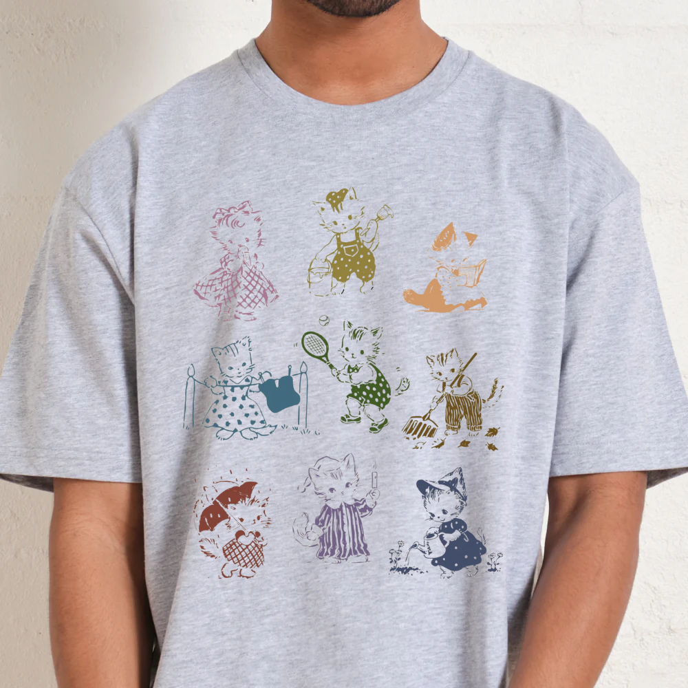 Gray t-shirt with colorful graphic design of cartoon characters on a plain background