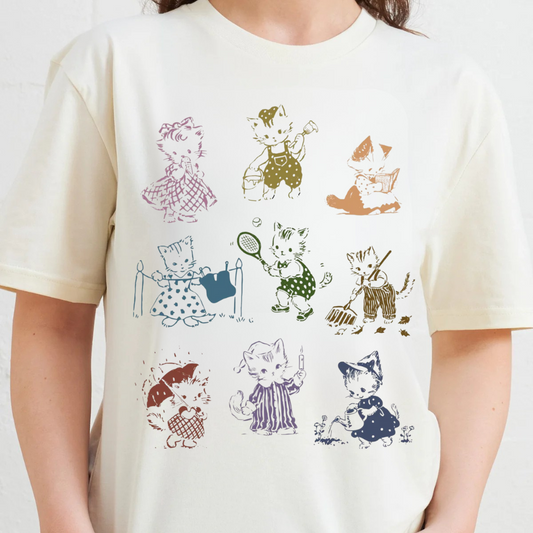 White t-shirt with vintage-style cat illustrations worn by a person