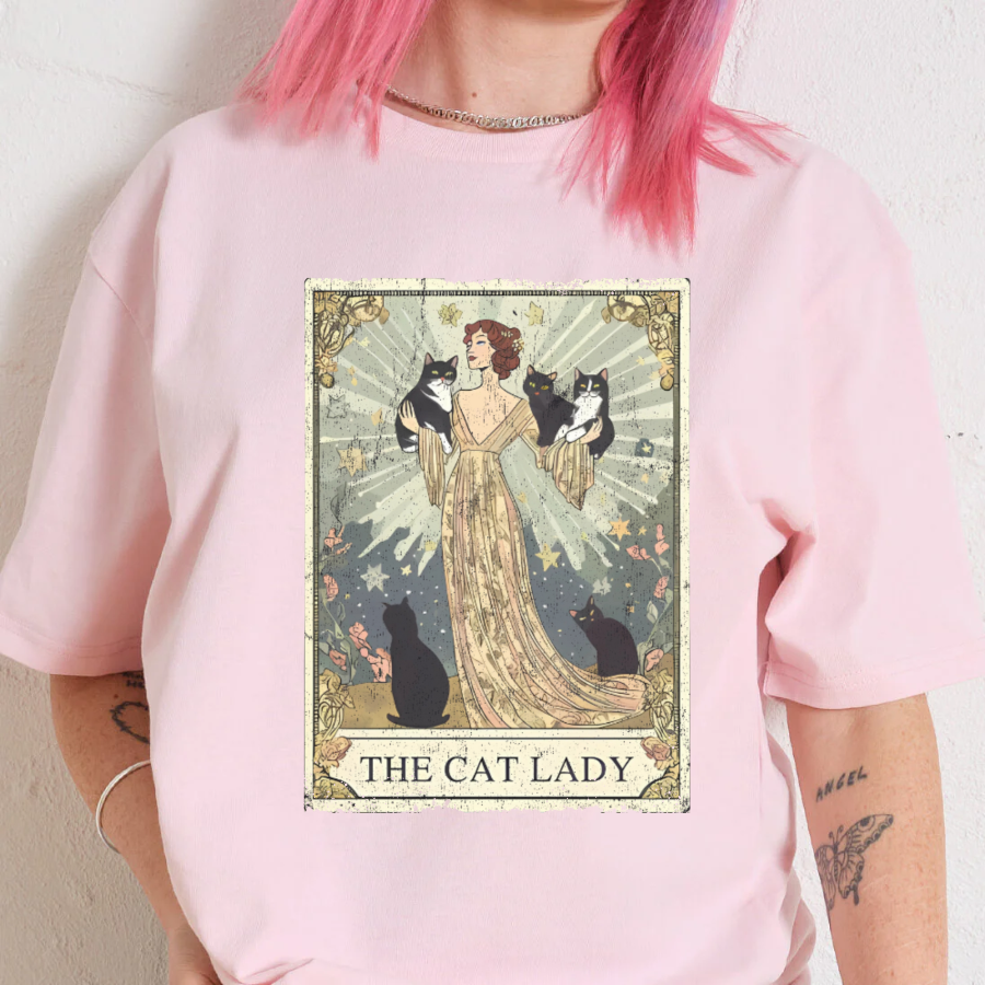 Person wearing a pink t-shirt with 'The Cat Lady' graphic design.
