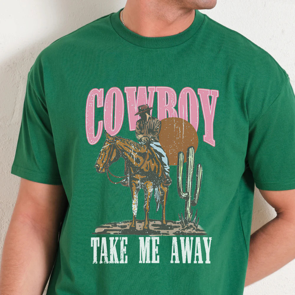 Green t-shirt with cowboy graphic and text 'Cowboy Take Me Away' on a plain background