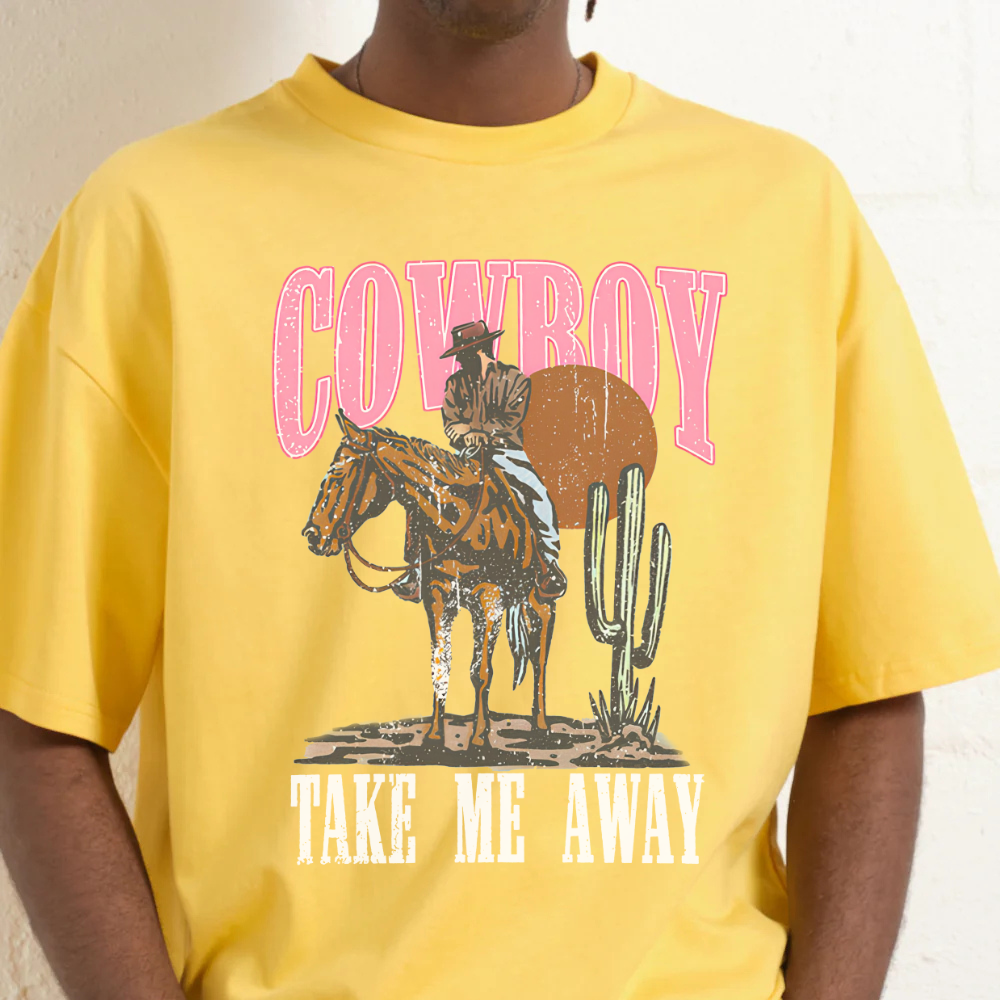 Yellow t-shirt with cowboy graphic and text 'Cowboy Take Me Away' on a plain background