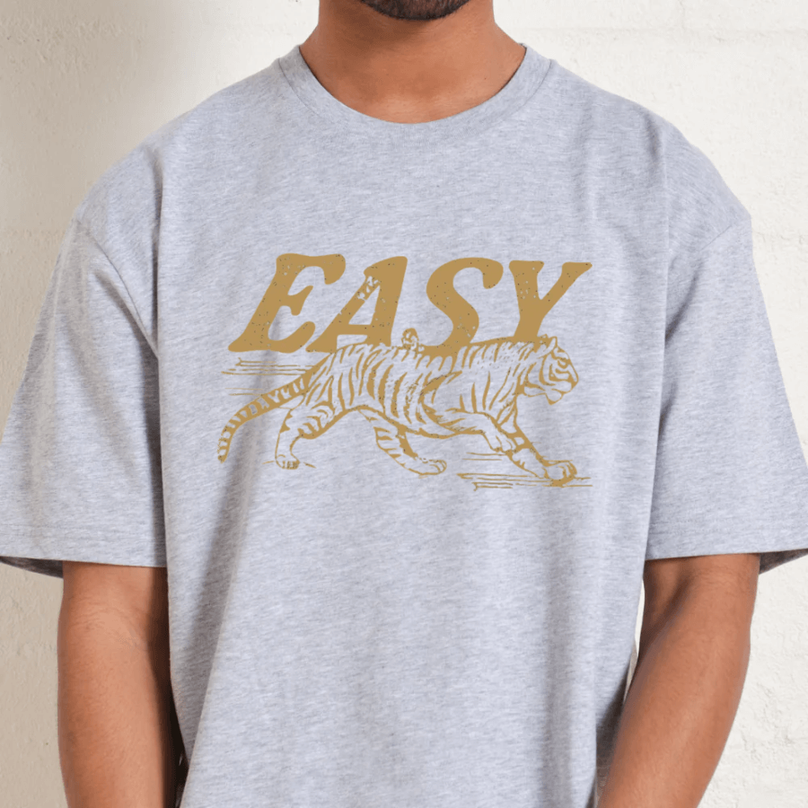Gray t-shirt with a gold tiger graphic and 'EASY' text on a neutral background