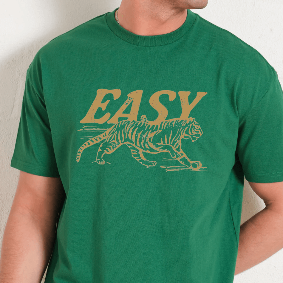 Green t-shirt with yellow tiger graphic and 'EASY' text on a plain background