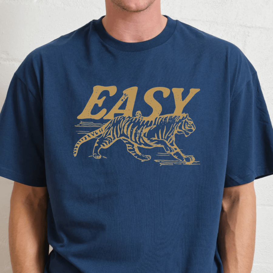 Person wearing a blue t-shirt with a yellow tiger graphic and 'EASY' text.