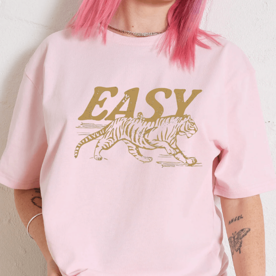 Person wearing a pink sweatshirt with a gold tiger graphic and 'EASY' text.