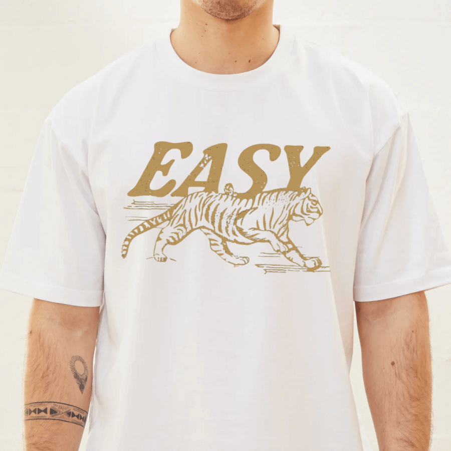 White t-shirt with a tiger graphic and 'EASY' text on a plain background