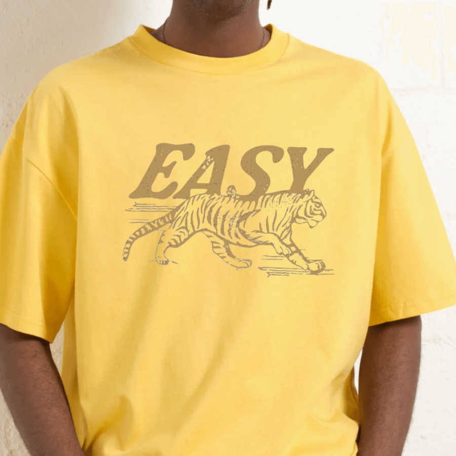 Yellow t-shirt with a tiger graphic and 'EASY' text on a plain background