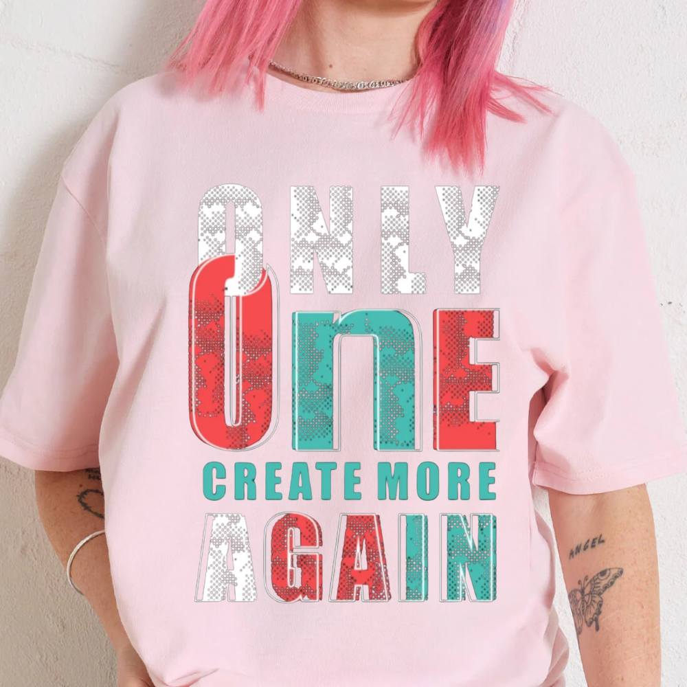 Premium oversized pink graphic tee featuring 'ONLY ONE CREATE MORE AGAIN' design, perfect for unisex styling.