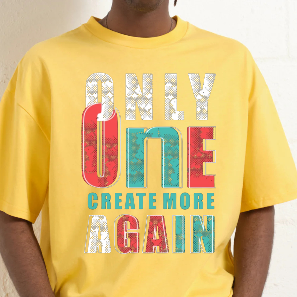 Premium oversized yellow graphic tee with 'Only One Create More Again' print, featuring a 90s-inspired boxy fit.