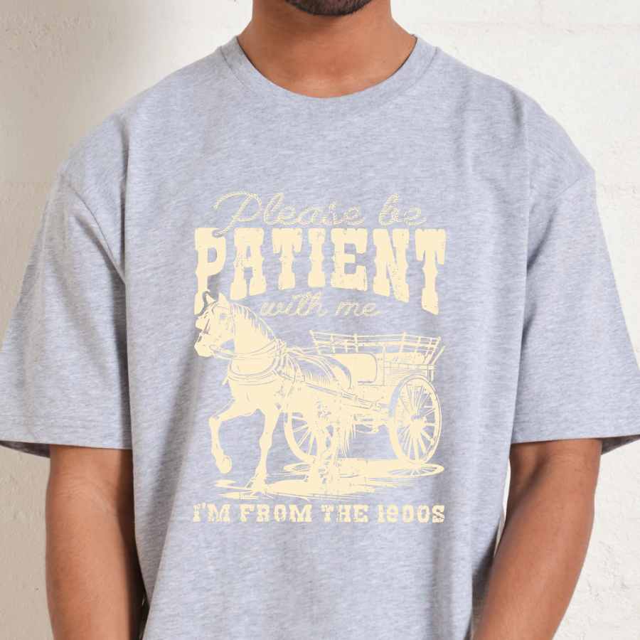 Gray t-shirt with yellow graphic and text worn by a person
