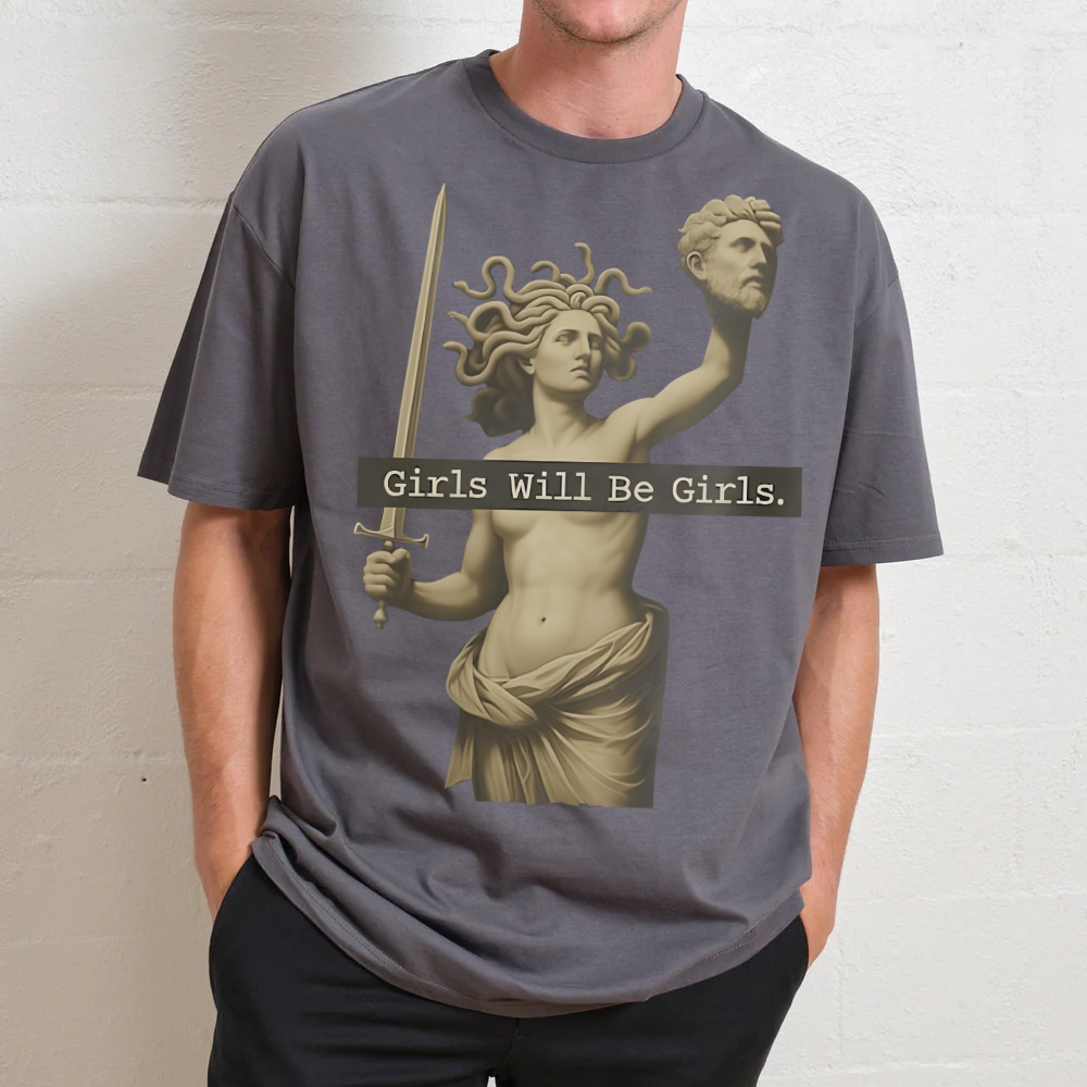 Person wearing a t-shirt with a graphic design and text 'Girls Will Be Girls' against a plain background