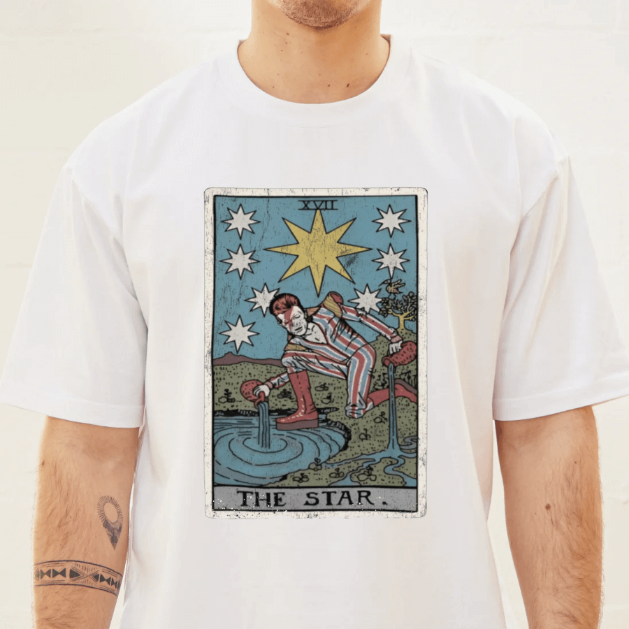 Person wearing a white t-shirt with 'The Star' tarot card design.