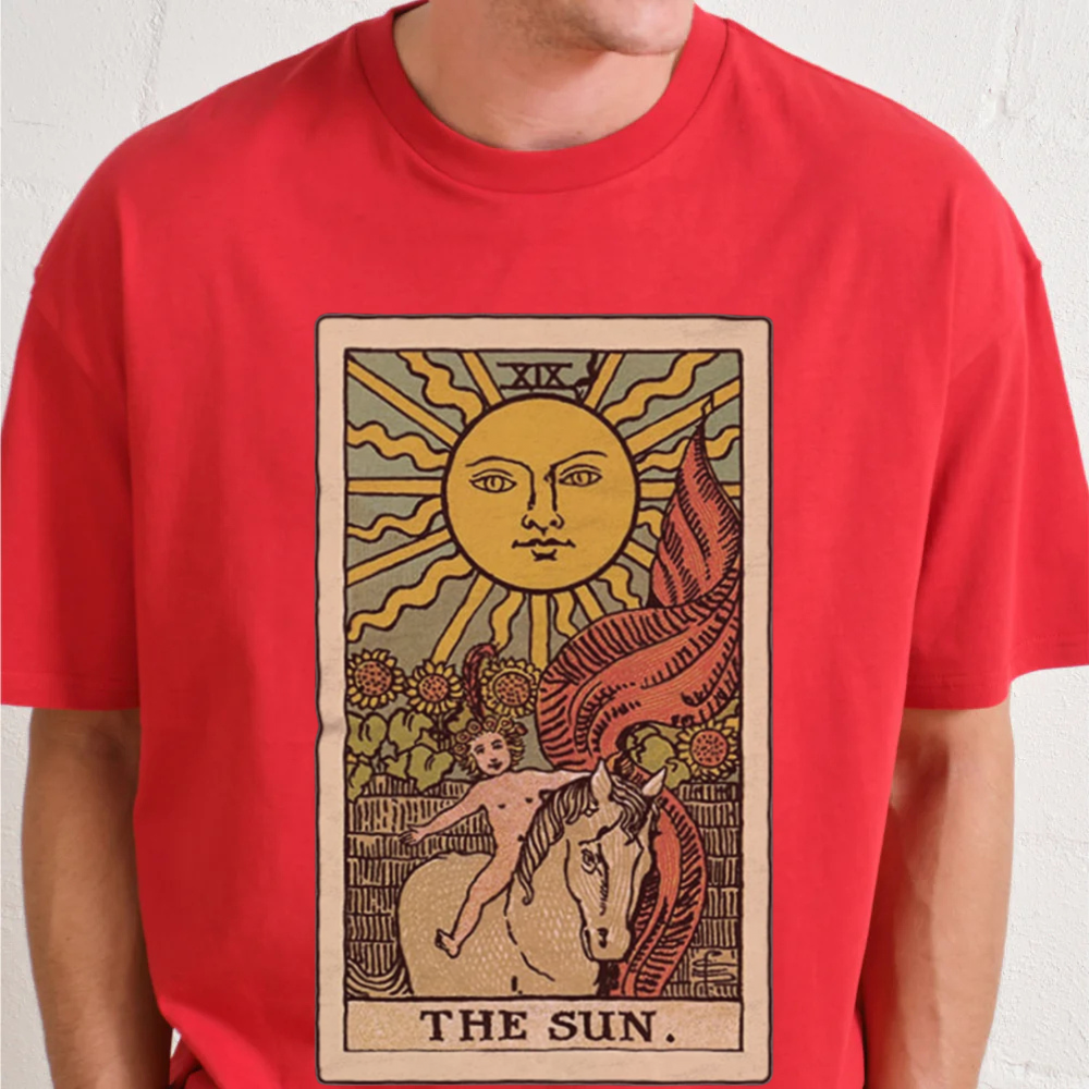Red t-shirt with 'The Sun' tarot card design on a plain background
