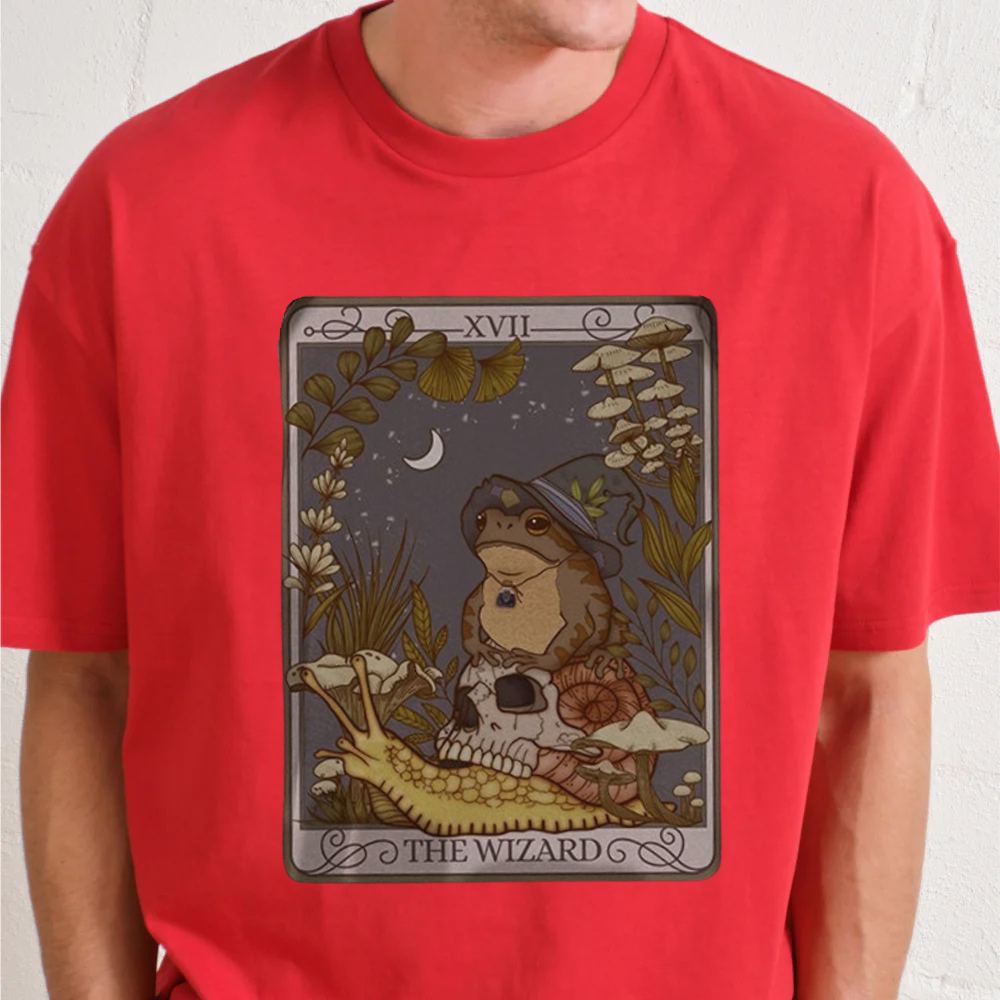 Red t-shirt with a graphic design of a tarot card featuring a wizard frog, on a plain background.