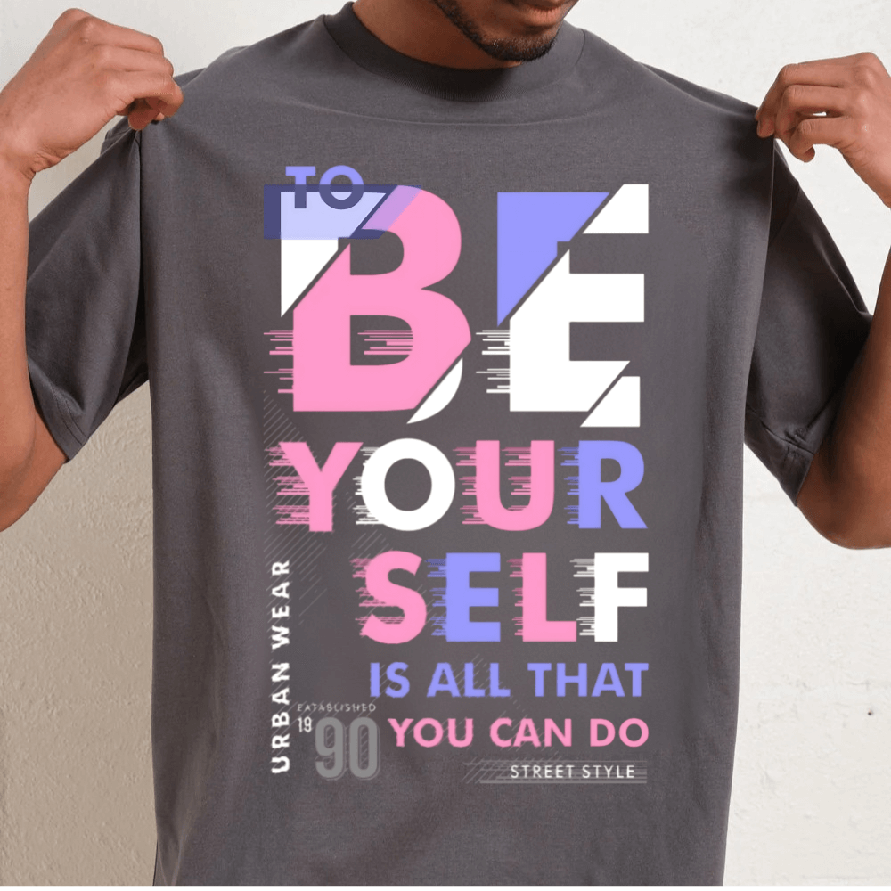 Oversized unisex graphic tee featuring 'To Be Yourself' slogan in vibrant typography, 90s-inspired design.