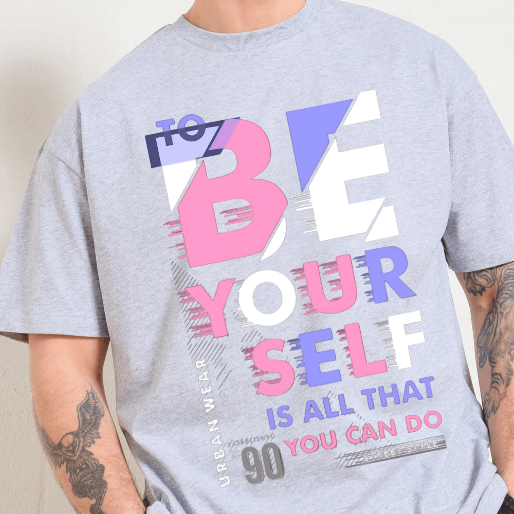 Oversized graphic tee featuring 'To be yourself' slogan in vibrant typography, 90s-inspired boxy fit, unisex design.